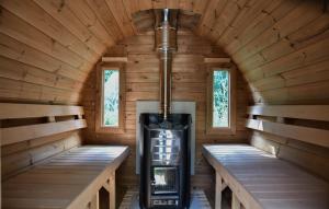 an inside view of a log cabin with a stove at The Cosy Cottage in Zeewolde