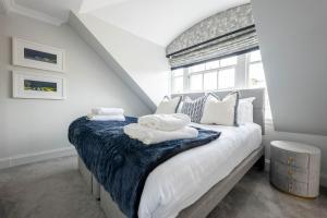 a bedroom with a large bed with towels on it at RÌGH Properties - Luxurious City Centre Three Bedroom Apartment in Edinburgh