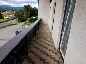 a balcony of a building with a wooden railing at Margarethner Appartments in Sankt Margarethen bei Knittelfeld