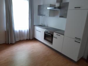 a kitchen with white cabinets and a stove at Margarethner Appartments in Sankt Margarethen bei Knittelfeld