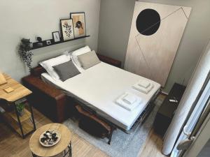 a small room with a bed and a table at COMFY DEN by Cozy Stories in Alexandroupoli