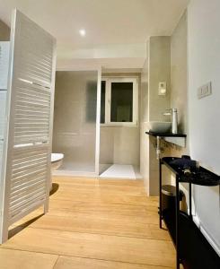 a small bathroom with a sink and a toilet at Apartamento "Villa Marinera" in Luanco
