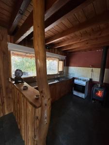 a kitchen with a stove and a stove top oven at Cabañas El Aljibe - Meliquina in Villa Meliquina