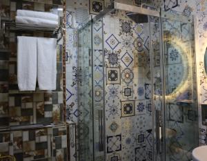 a shower in a bathroom with blue and white tiles at Galata istanbul Hotel in Istanbul +126 photos