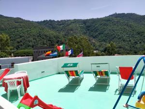 a group of chairs and tables on a roof at Luigiane B&B in Acquappesa