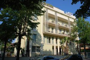 a white building with balconies on the side of it at Zen Hotel Versilia in Marina di Pietrasanta