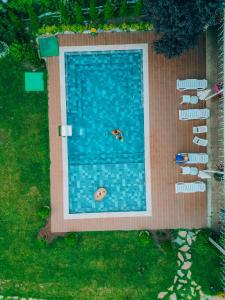 an overhead view of a swimming pool with people in it at Lotus Sapanca-Private Villa with private Pier and heated pool in Serdivan