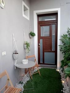 a small patio with a table and a door at Casa Vacanze MURANUM - B&B in Morano Calabro