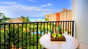 a table with a basket of fruit on a balcony at Maui Westside Presents: Kaanapali Shores 733 Stunning Ocean Views NEW LISTING in Lahaina