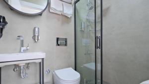 a bathroom with a shower and a toilet and a sink at Centralflatsfethiye in Fethiye