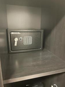 a microwave oven with a cup on a shelf at la Maison del Mas Family in Elmas