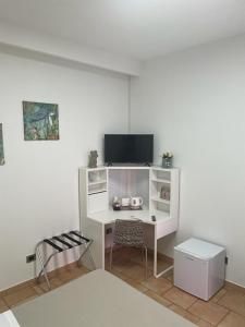 Elmasにあるla Maison del Mas Familyのテレビと椅子のある机のある部屋