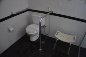 a bathroom with a toilet and a sink at Constantino Hotel e Eventos in Juiz de Fora