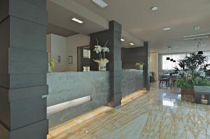 a lobby with a reception desk in a building at Zen Hotel Versilia in Marina di Pietrasanta