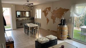 a living room with a table and a world map on the wall at Chez Ced&Lolo in Béziers