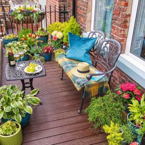 a patio with a bench and a table and potted plants at The Mainstay Luxury Boutique Rooms with Private Parking in Whitby