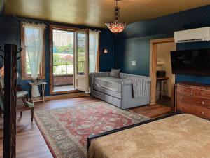 a living room with a couch and a tv at Endion Inn in Duluth