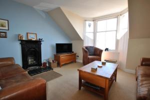 a living room with a couch and a fireplace at Bayview- relaxing home by the sea in Saint Monance