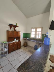 a kitchen with a sink and a counter in a room at Barreirinhas - Chalé Tubarão in Barreirinhas