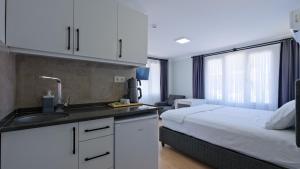 a kitchen with a sink and a bed in a room at Centralflatsfethiye in Fethiye