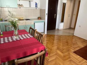 a kitchen with a table with a vase of flowers on it at Volkan Apartments in Ohrid