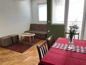 a living room with a table and a couch at Volkan Apartments in Ohrid