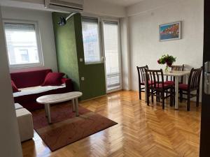 a living room with a table and chairs and a couch at Volkan Apartments in Ohrid