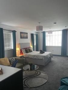a living room with a bed and a couch at Entire Brand New Serviced Apartment in Moseley in Birmingham