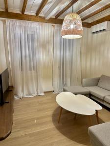 a living room with a couch and a table at Alemarni Syros in Ermoupoli