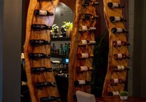 a wall filled with wine bottles at Art Hotel Boutique in San Pedro Sula