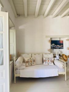 a white couch with pillows in a room at Agnanti Beach House in Patmos