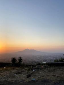 a view of a mountain with the sun setting in the horizon at Domus Sici in Pompei