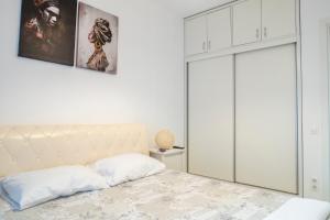 a bedroom with a bed with a white headboard at GviTown Central Apartment in Bucharest