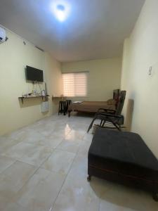 a large room with a bed and a couch in it at Blue House - Via a la costa in Guayaquil