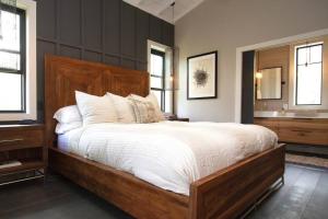 a bedroom with a large bed and a sink at NEW Rustic Modern Cabin at Lutsen Mountains in Lutsen