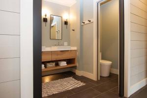 a bathroom with a sink and a mirror at Ski, Golf, Trails, Winery, Lake View, Lutsen, Grand Marias - Sleeps 8 in Lutsen +11 photos