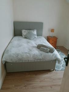 a bedroom with a large bed with a wooden floor at Barrow mews views in Carlow