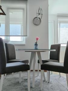 a dining room with a glass table and two chairs at Green Harmony Apartment in Pale