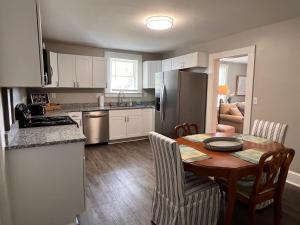 a kitchen with a table and a kitchen with a refrigerator at My Historic Home in Greer