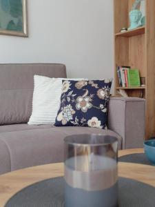a glass of water on a table in front of a couch at Green Harmony Apartment in Pale