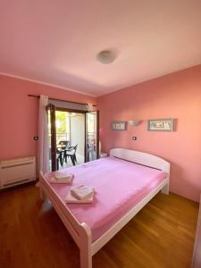 a bedroom with a large bed with pink sheets at Apartment Center Adria in Bar