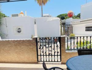 a balcony with a black gate and a table and a basketball at Apartamento Playa Grande in Tías