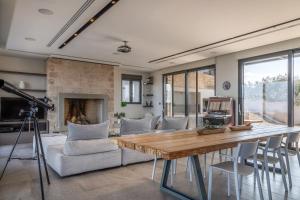 a living room with a table and a couch at The Olive Hill in Ássos