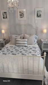 a bedroom with a white bed with pillows at 66 Chaucer B&B with Complimentary Breakfast to Go Bag in Cambridge