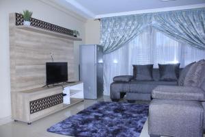 uma sala de estar com um sofá e uma televisão em Mutshinyalo Residence em Thohoyandou
