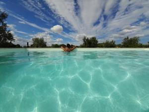 una persona nadando en una gran piscina de agua en Monte do Rochinha en Monte da Cardosa