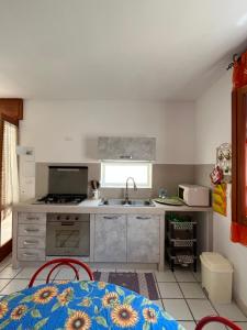 a kitchen with a sink and a stove at Villetta Santa Maria in Leuca