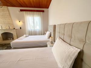 Postel nebo postele na pokoji v ubytování Magdalini House