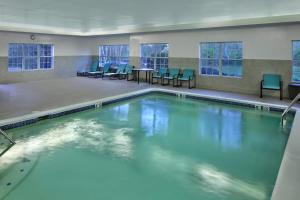 a swimming pool with blue water in a building at Residence Inn Mystic Groton in Mystic