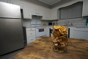 a kitchen with a vase filled with mushrooms on a table at ZEN'S Retreat in North Little Rock +10 photos